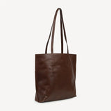 JOYN Bags' Everyday Tote in Heritage Brown (a very dark, rich coffee color). Sustainably made with full-grain remnant leather. Shown from the side.