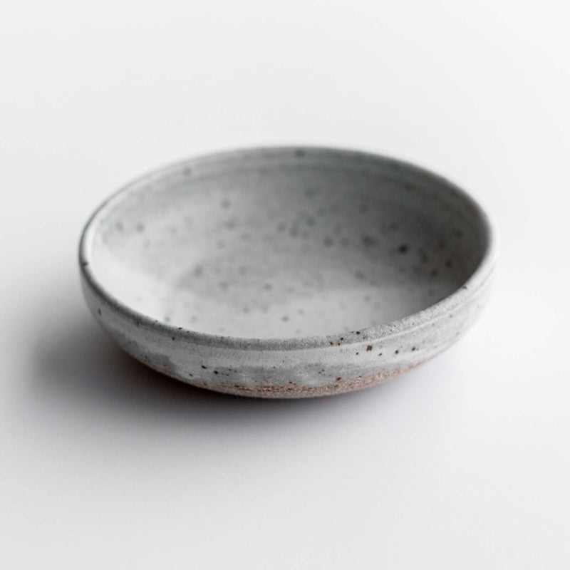 Handmade ceramic condiment dish in matte speckled grey. Made by Colleen Hennessey. Approximately 4" in diameter and 1-1.5" deep.
