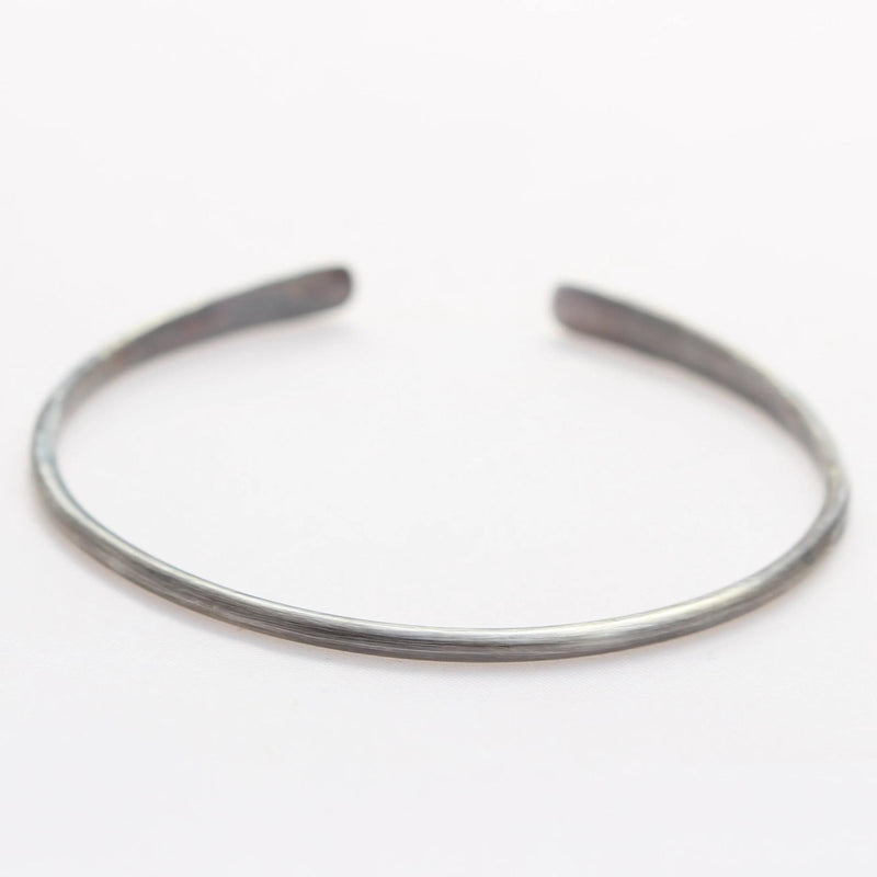 Back view of the oxidized silver open-ended bangle bracelet.