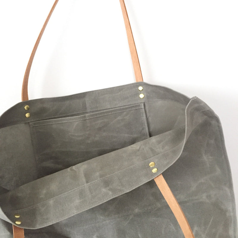 Aluminum-colored hand-waxed cotton market tote with inside pocket, French seams and veg-tan leather handles.