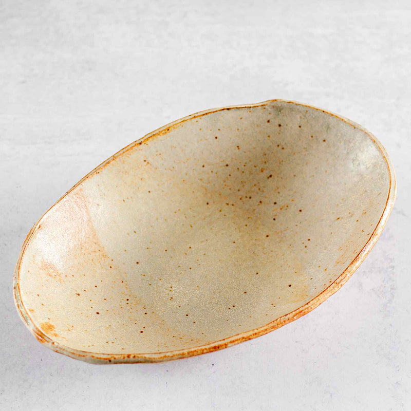Top view of Colleen Hennessey's oval ceramic bowl in rust and wheat.