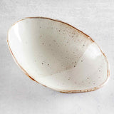 Top view of Colleen Hennessey's oval ceramic bowl in glossy speckled white.