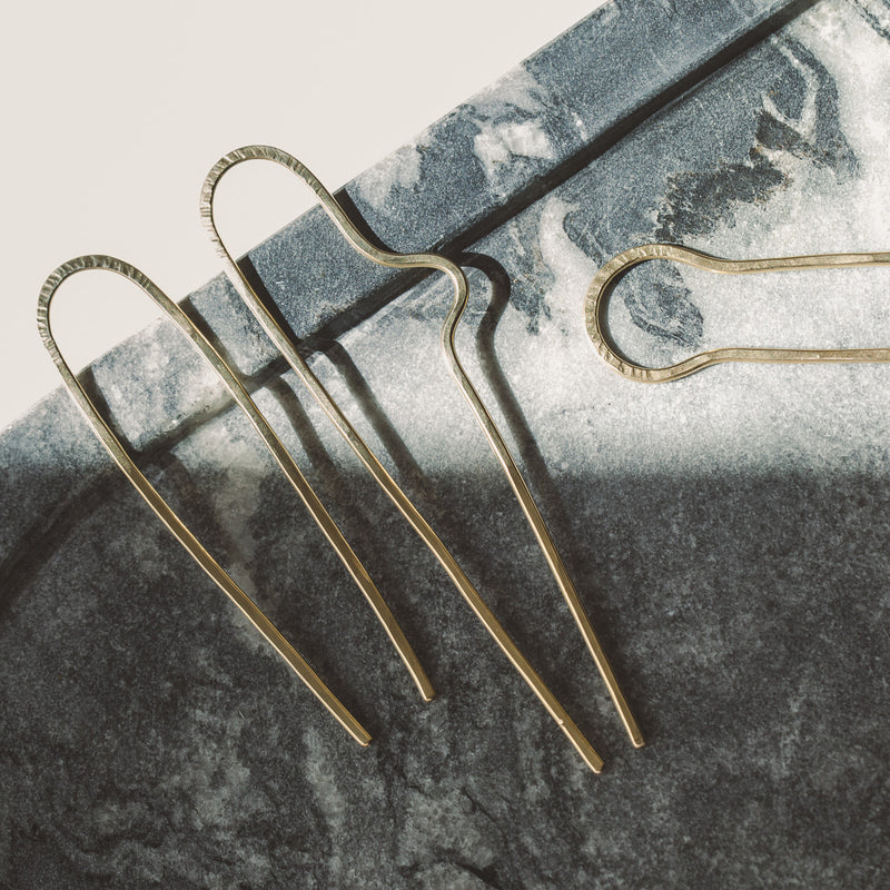 Hammered brass hair pins by Desert Moon. The left is the single curve style in small; the right is the double curve in large.