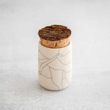 Earthen spice jar in matte crackle white glaze and raw bark cork lid.