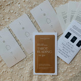 Homebound Tarot's Tarot Reading to go packet in desert, with cards and explanations displayed.