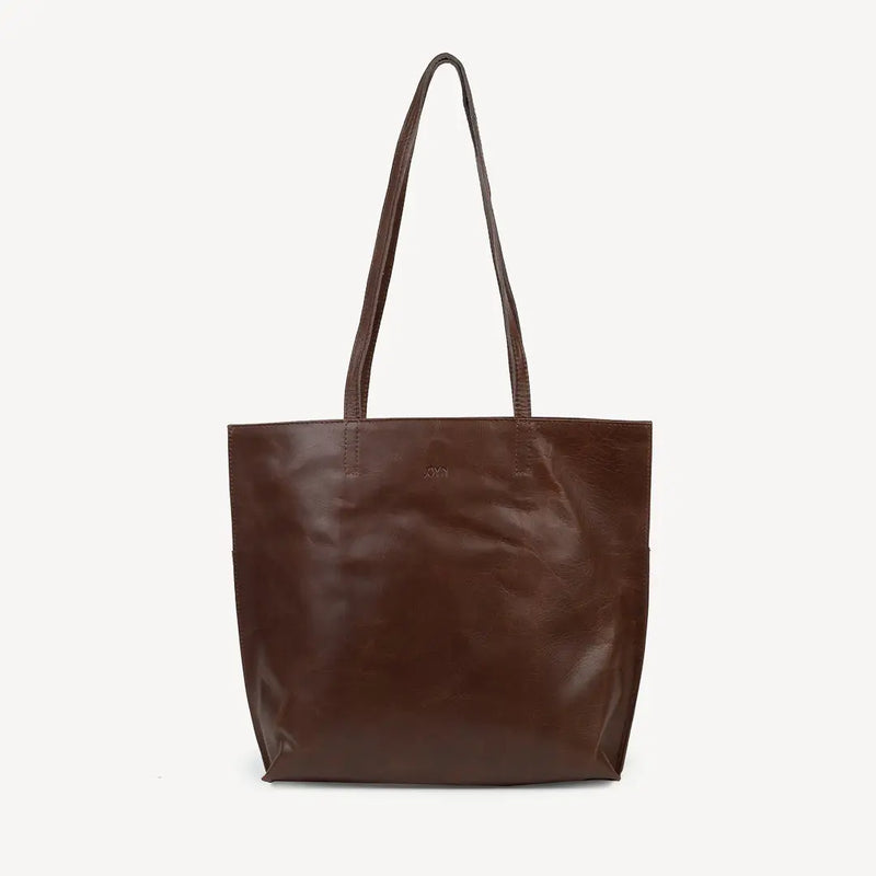 JOYN Bags' Everyday Tote in Heritage Brown (a very dark, rich coffee color). Sustainably made with full-grain remnant leather. Shown from front. The JOYN logo has been stamped into the leather.