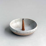 A single Hana-koh incense cone burning in a Colleen Hennessey ceramic dish.