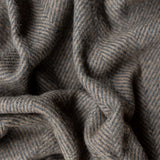 A close-up shot of the charcoal and coffee herringbone recycled wool blanket by The Tartan Blanket Co.