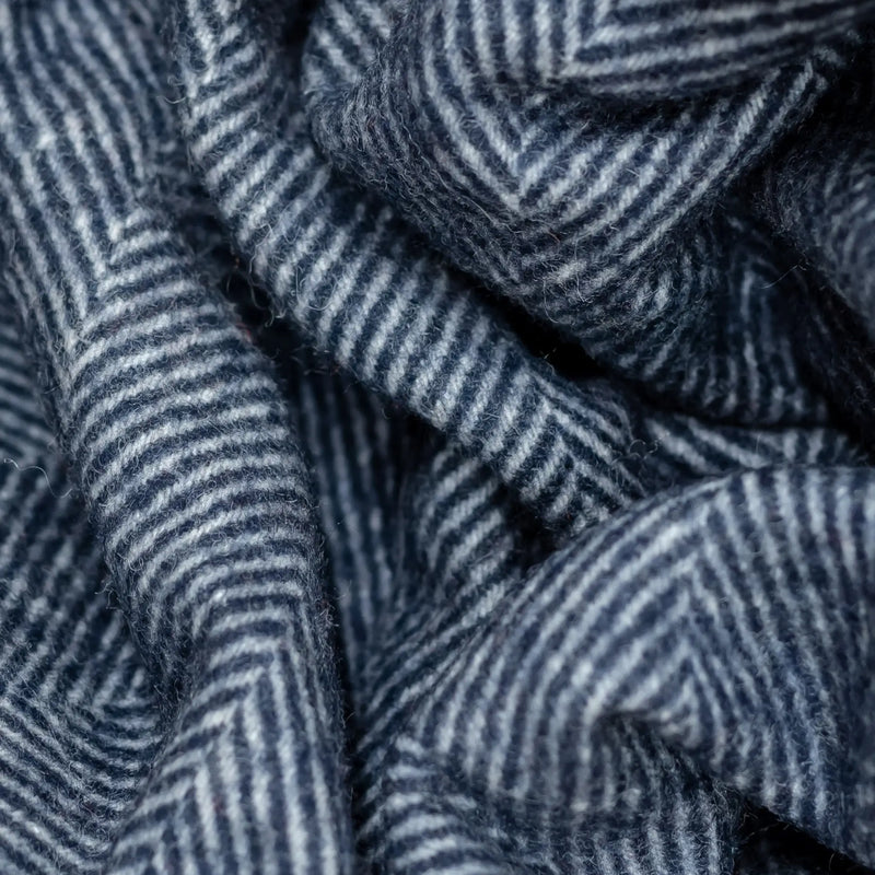 A close-up shot of the large recycled wool pet blanket's navy herringbone pattern.