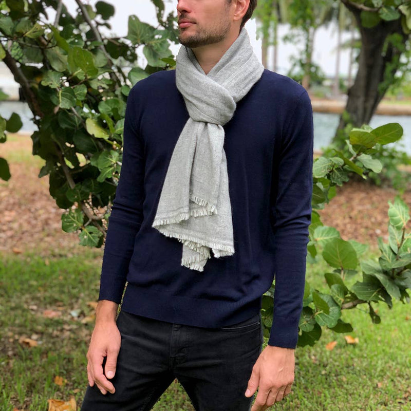 Himalayan cashmere scarf in grey worn by a man.